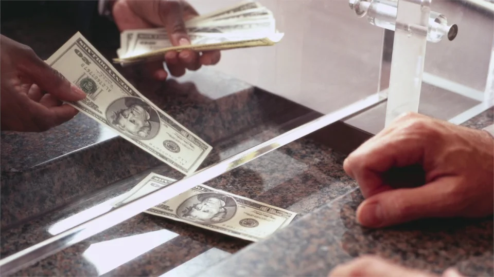 A person depositing money in the bank.