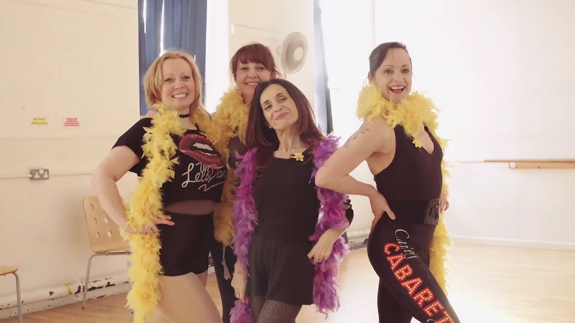 4 women posing with feather boas