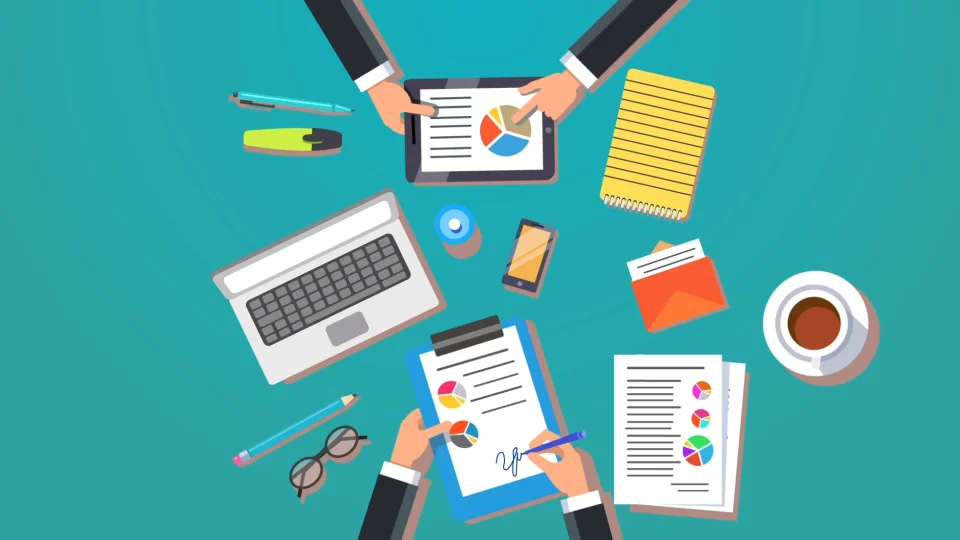 Illustration depicting an overhead view of two people wearing black jackets working above a green tabletop. The first person is in the top center and the second is in the bottom center. The top person is examining the pie chart on a tablet computer. The bottom person is signing a sheet with pie charts being held in a clipboard with a blue pen. Other items spead out on this workspace include: a green pen, a yellow highlighter pen, a laptop computer, a blue pencil, a pair of oval-shaped spectacles, sheets of paper depicting pie charts, a cup of coffee, an orange envelope with a letter sticking out of it, a yellow spiral pag, a smartphone, and an open drink container.